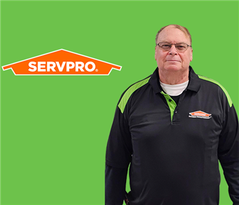 a man in front of a servpro background