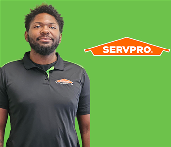 a man in front of a servpro background