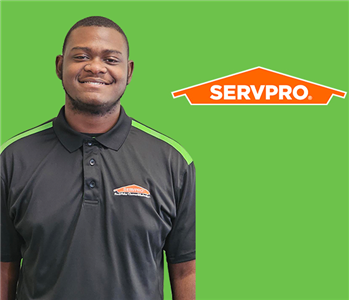 a man in front of a servpro background