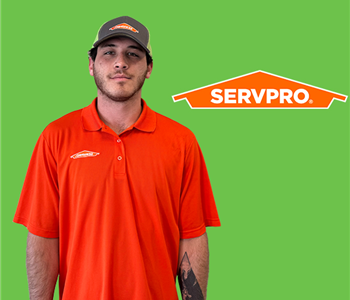 a man in front of a servpro background