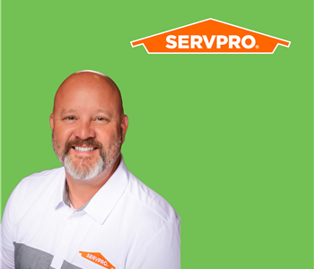 woman in front of SERVPRO logo