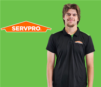 a man in front of a servpro background