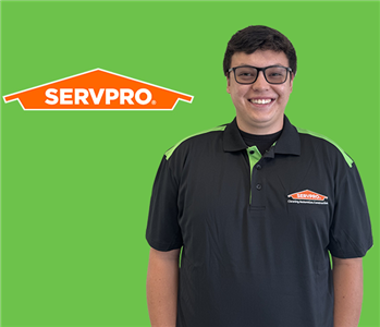 man in front of servpro logo