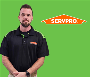 a man in front of a servpro background